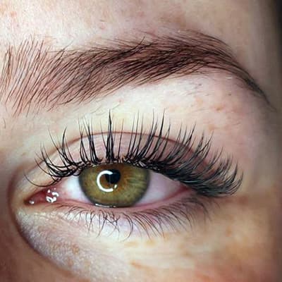 Happy client smiling confidently after receiving classic eyelash extensions in Melbourne from Diamond Eyelash Extensions, showcasing the satisfaction and boost in self-esteem