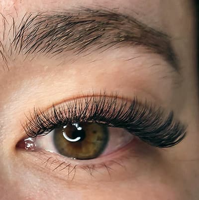 Hybrid eyelash extensions by Diamond Eyelash Extensions in Melbourne on dark eyes, showcasing the enhancement of natural beauty and definition.