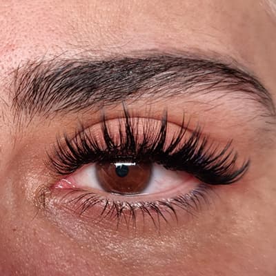 Wispy eyelash extensions by Diamond Eyelash Extensions in Melbourne on dark eyes, showcasing the enhancement of natural beauty and definition.